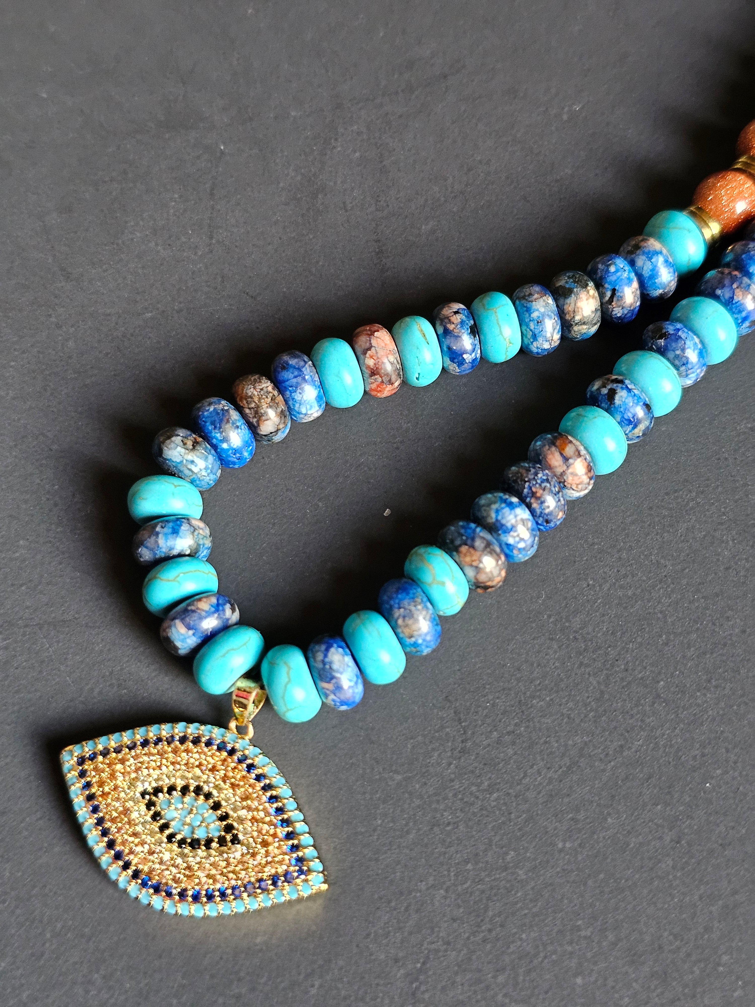 Rhyolite, Blue Howlite, Goldstone & Gold Hematite ft. Nazar Pendant