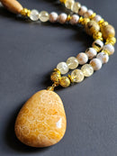 White Reconstructed Shell, Citrine, & Sunstone ft. Gold Lava Rock & Fossilized Coral Pendant