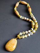 White Reconstructed Shell, Citrine, & Sunstone ft. Gold Lava Rock & Fossilized Coral Pendant